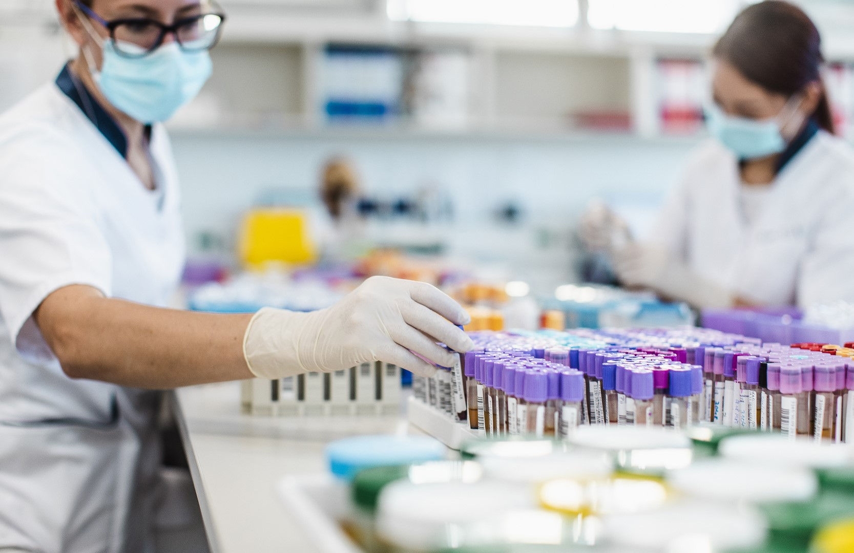 man wearing a mask and gloves in a science lab