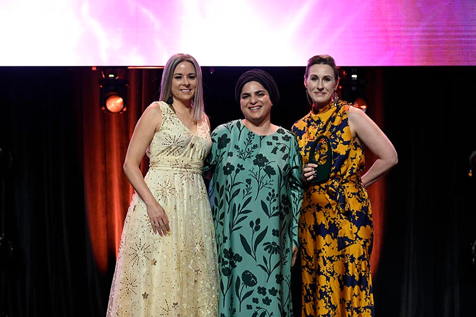 People on a stage recieving an award.