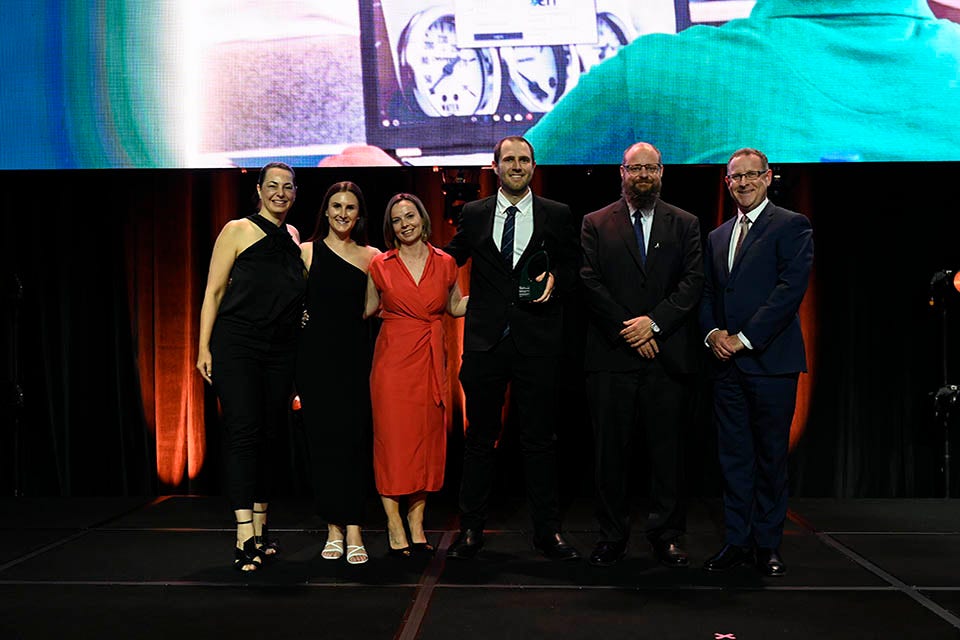 People on a stage recieving an award.