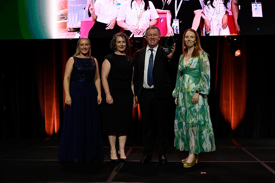 People on a stage recieving an award.