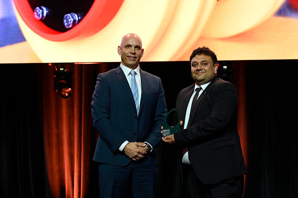 People on a stage recieving an award.