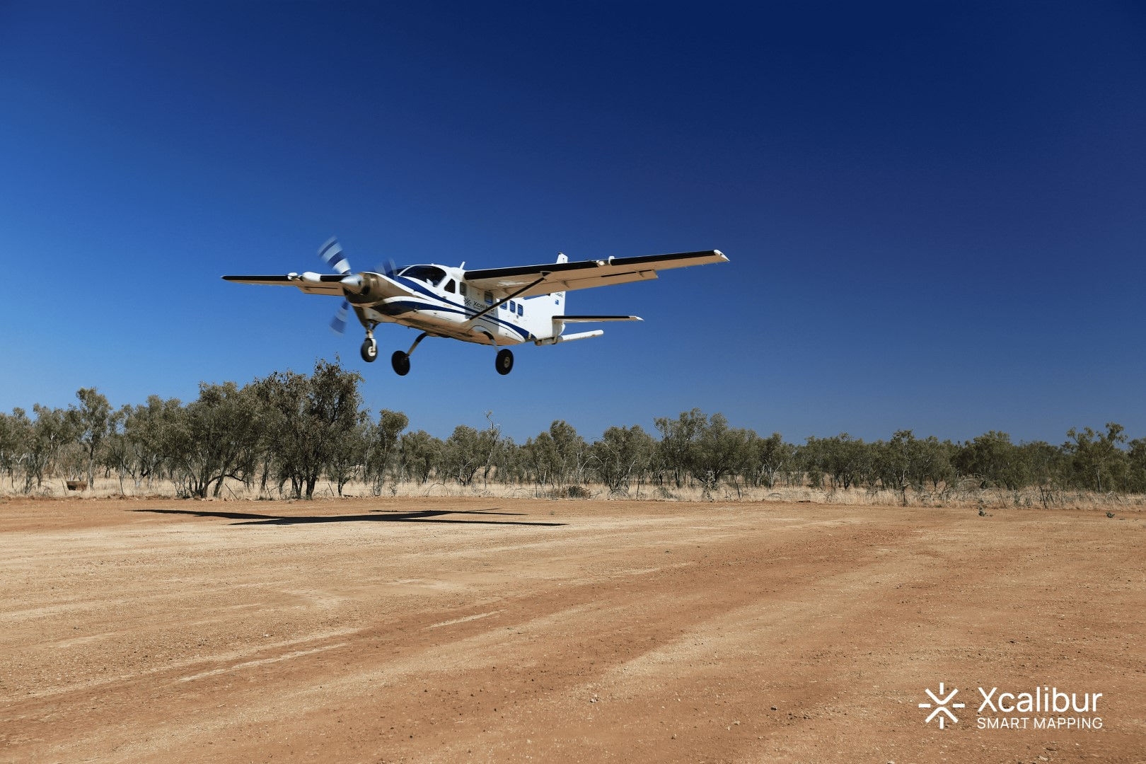 plane taking off a dirt runway