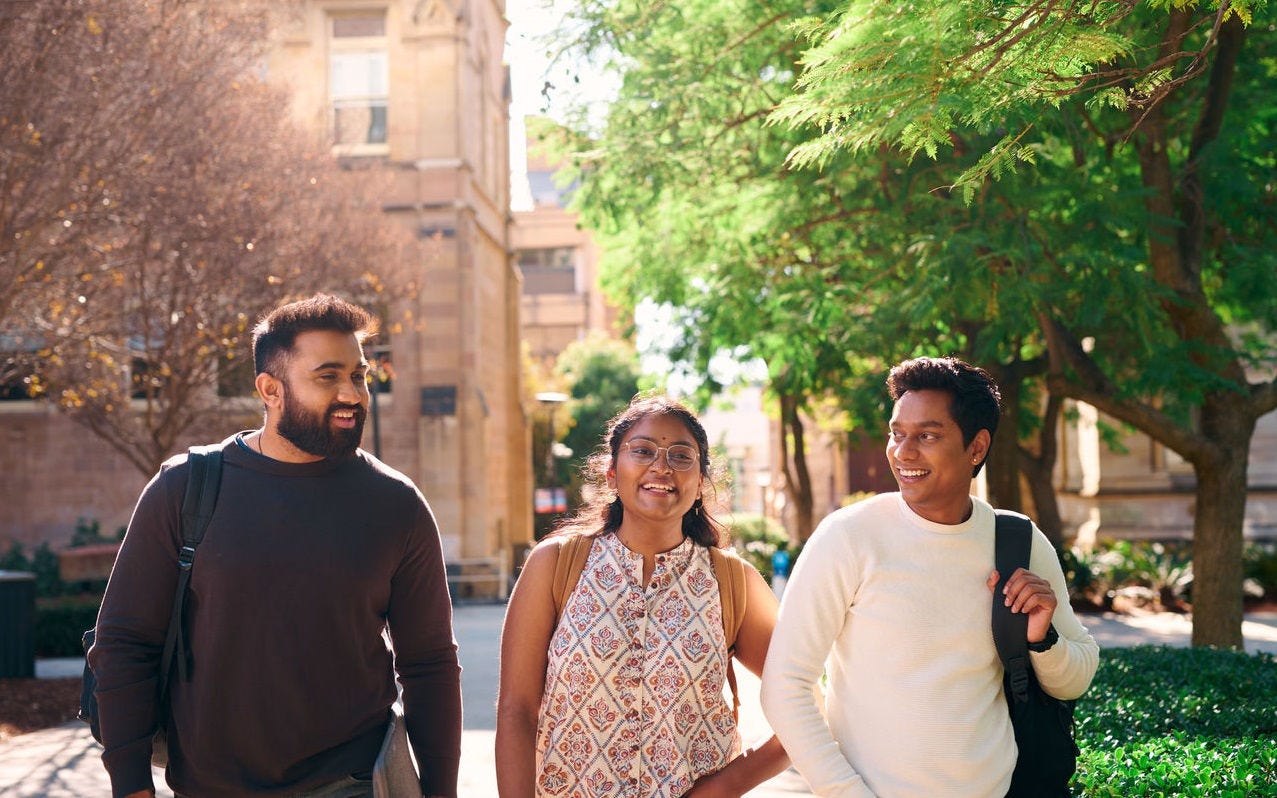 3 students on campus walking