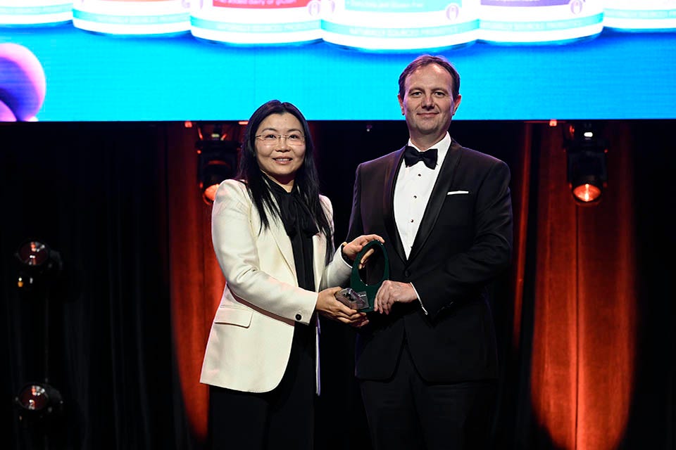 People on a stage recieving an award.