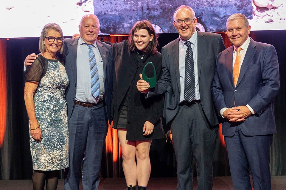 People on a stage recieving an award.