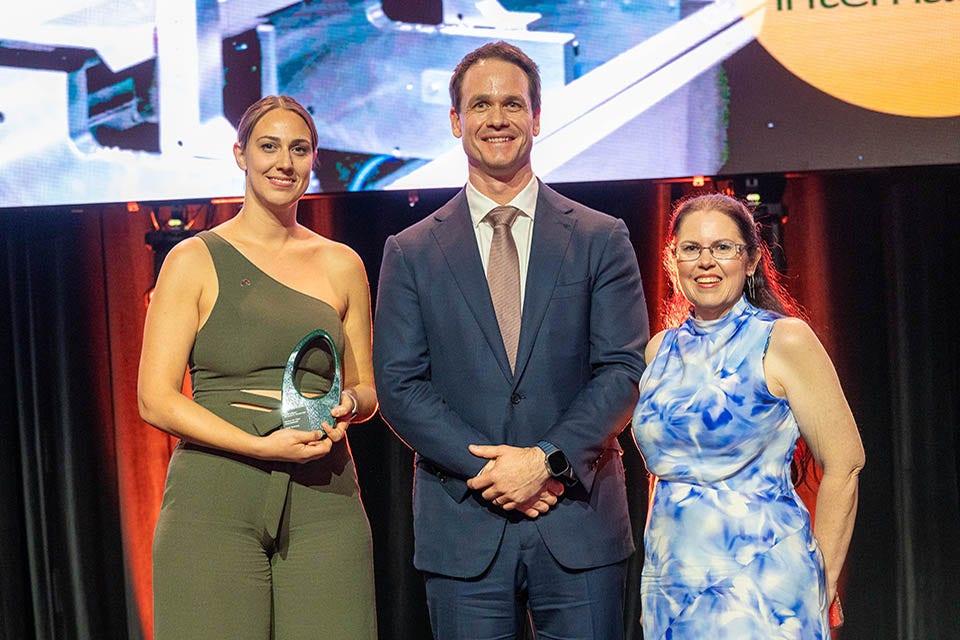 People on a stage recieving an award.