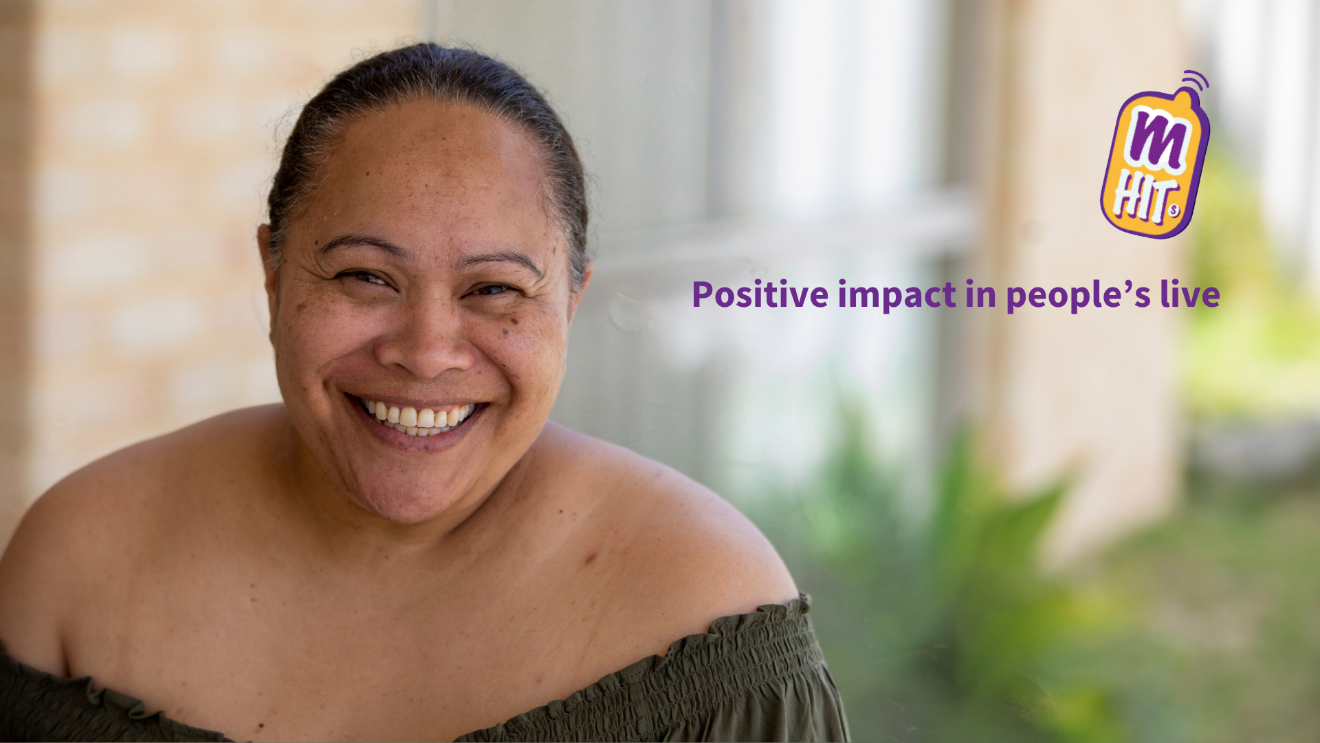 woman smiling with a house window in the background