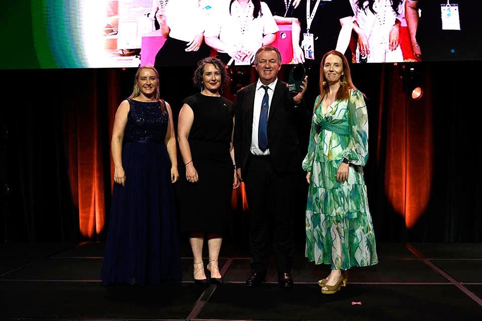 People on a stage recieving an award.