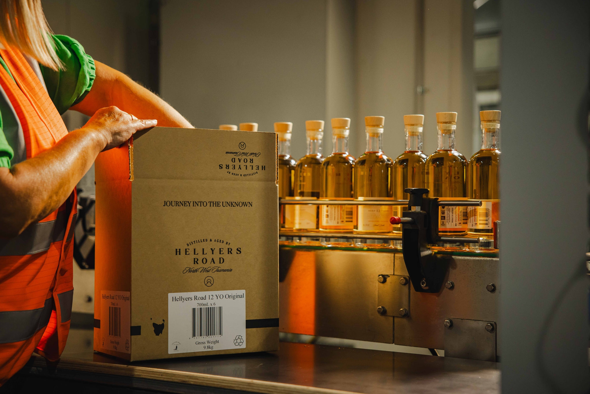 person packing beverages into box