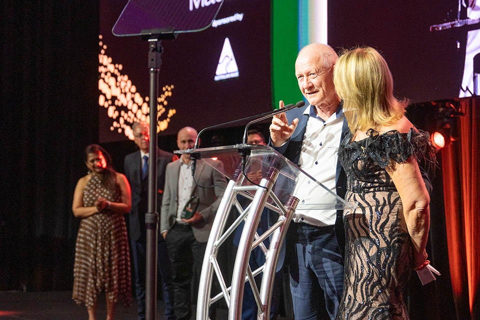 People on a stage recieving an award.