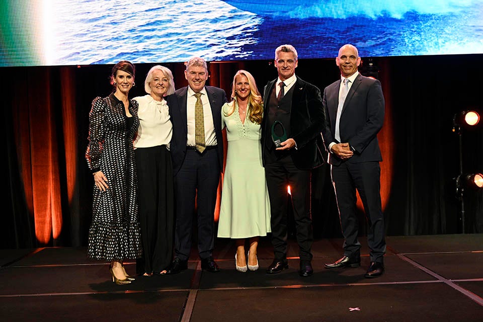 People on a stage recieving an award.