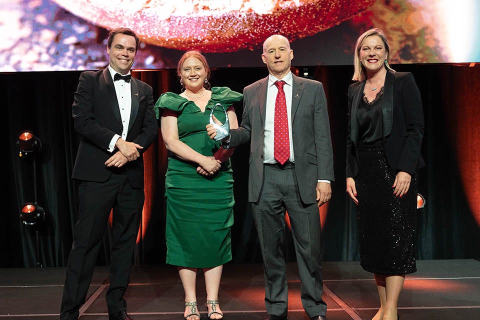 People on a stage recieving an award.