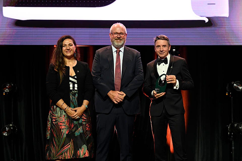 People on a stage recieving an award.