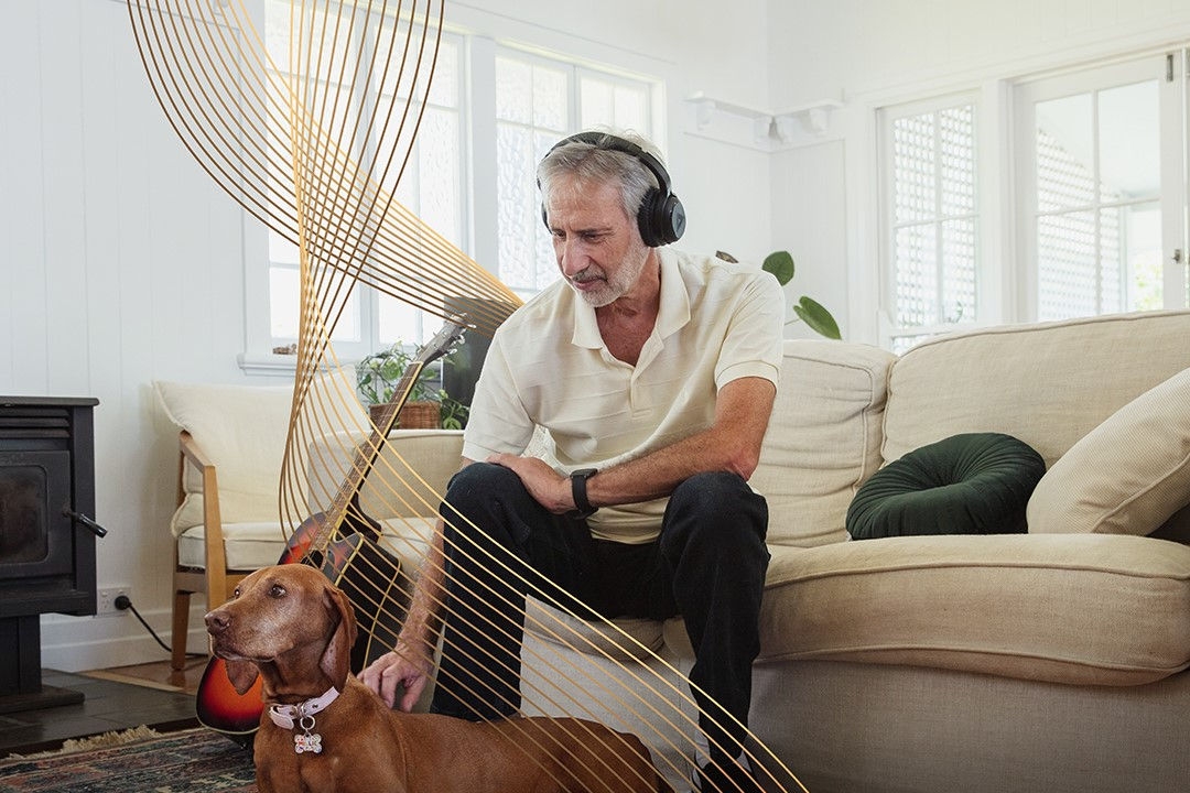 man sitting on couch with headphones on