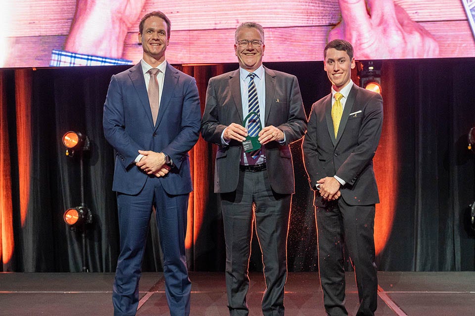 People on a stage recieving an award.